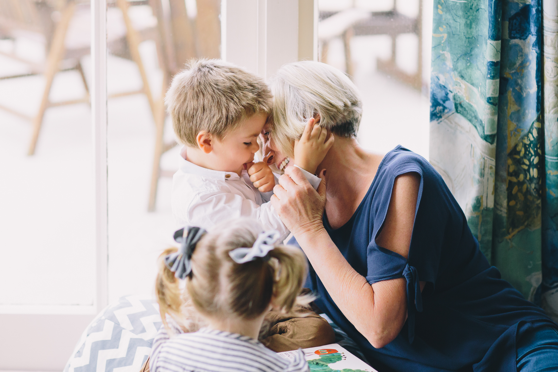 grandmother laughing and smiling with toddlers Wellington in home family photography natural light