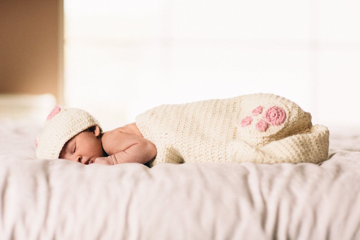 baby girl with hat on on my bed Newborn Photography Wellington