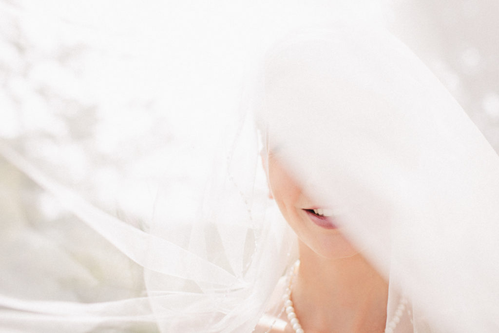 bride with veil in sunlight natural light Wellington rainy day wedding