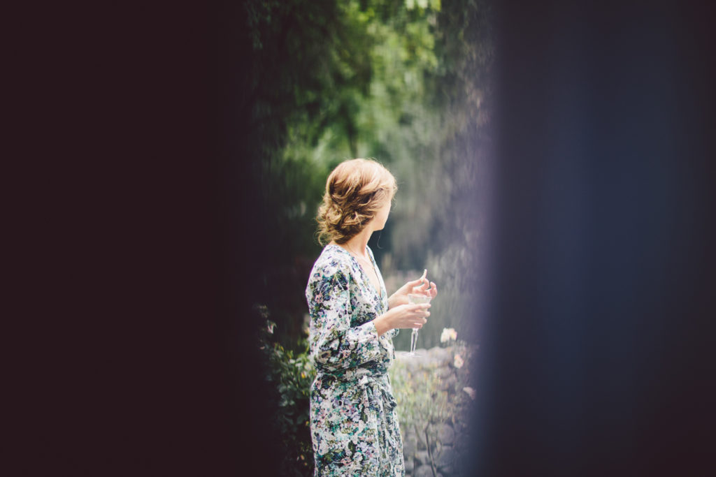 woman staring off in the distance in floral robe natural light Wellington wedding